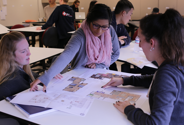 Students discussing floorplan designs